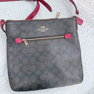 Coach Crossbody Bag - Signature coated canvas with red accents.